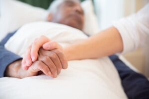 hospice patient laying in a bed while receiving care