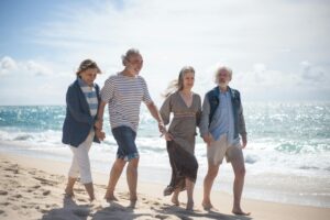 Retired seniors walking on a beach